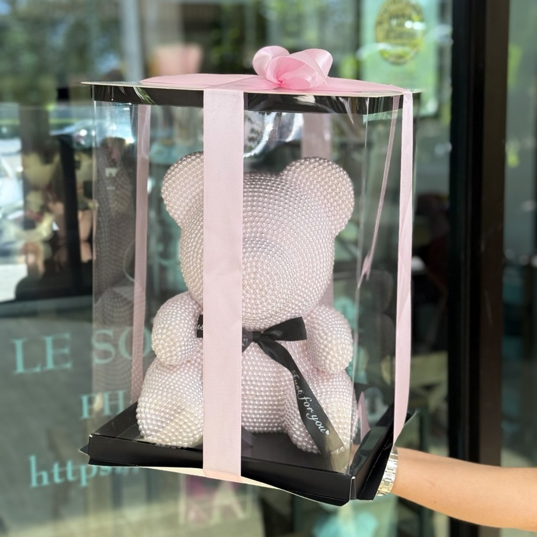 Pink Pearl Teddy Bear covered in pearl-like beads, presented in a clear gift box with pink satin ribbon